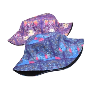 Reversible bucket hat with psychedelic Buddha head print in purple and blue artistic patterns