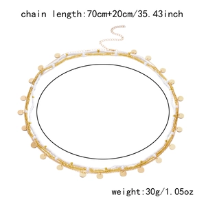 Flat lay of a bohemian gold disc and bead waist chain showing 70cm+20cm length detail