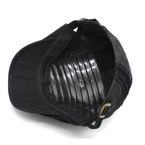 Detail of cotton beret featuring quilted side panels and adjustable metal strap buckle