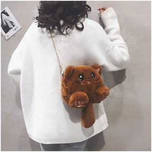 Détail du sac chat en peluche marron avec chaîne dorée porté par un mannequin