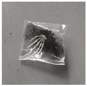 Halloween ghost hand hair clip with black mesh and skull bone detail in clear packaging