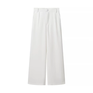 Detail of white wide-leg trousers featuring sharp pleats and a high-quality smooth fabric