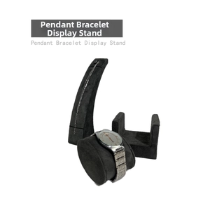 Macro shot of dark grey velvet jewelry display set featuring watch pillow and pendant stand