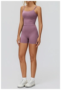 Detail of high-waisted scrunch yoga shorts and U-neck sports bra in soft mauve purple