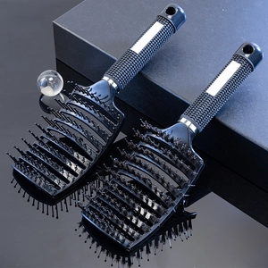Two black curved vented hairbrushes with boar bristles and non-slip rubber handles