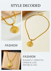 Detail of gold snake chain necklace featuring a textured disc pendant and elegant jewelry box