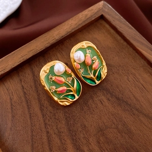 Detail view of vintage oil painting style earrings with tulip design and pearls