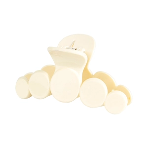 Detail view of beige matte resin hair claw clip with smooth five-ring cloud design