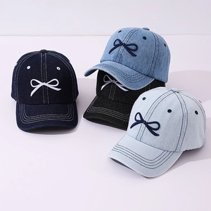 Kids denim baseball caps in multiple colors featuring a small embroidered bow decoration