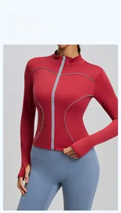 Detail of red slim fit yoga jacket with gray trim and functional thumbhole cuffs
