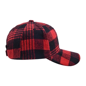 Detail of red and black buffalo plaid wool baseball cap showing thick fabric texture