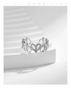 Detail of adjustable 925 silver ring featuring sparkling zircon heart hollow pattern