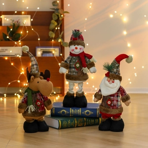 Charming trio of plush Christmas figurines including Santa, Snowman, and Reindeer on books