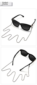 Detail of sleek black square sunglasses with a matching minimalist metal snake chain strap