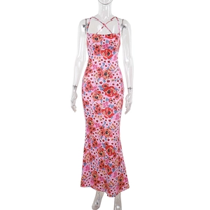 Close-up of pink floral maxi dress with vibrant red flower prints and X-cross neckline