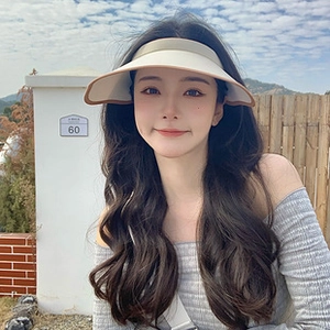 Detail of a light beige sun visor hat with brown trim edge for women in summer