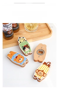 Close-up of animal wood magnetic bottle openers with cat, bear and monkey patterns