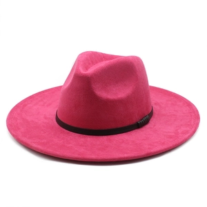 Detailed close-up of bright rose pink suede fedora with wide brim and black ribbon band