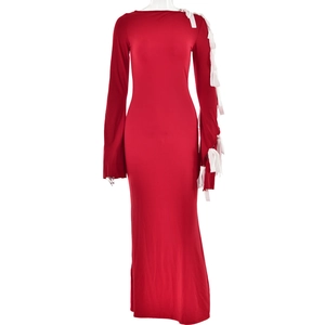 Detail of red long-sleeved dress featuring white decorative bows on the sleeve