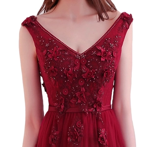 Detail of V-neck burgundy evening gown with 3D floral embroidery and hand-beaded sequins