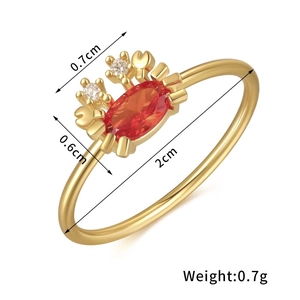 Macro detail of crab-shaped gold ring with red stone and dimensions showing 0.7g weight