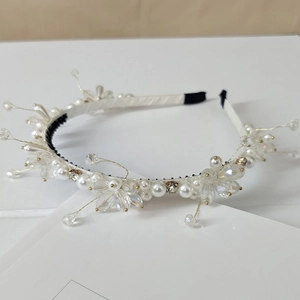 Detail of handmade bridal headband with white pearls and sparkling crystal beads