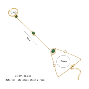 Detail of gold hand harness featuring a green oval zircon and size specifications