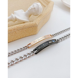 Close-up of His Queen and Her King engraved stainless steel couple bracelets with zircon