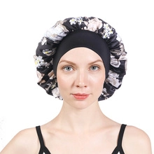 Detail of floral satin bonnet with double-layer lace and wide elastic headband