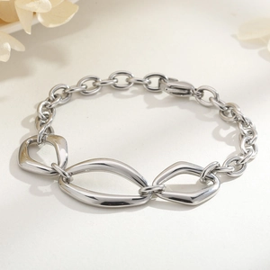 Macro view of geometric silver steel bracelet with link chains and floral decoration