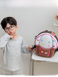 Close-up of cute 3D cupcake shape kids backpack with colorful dots and strawberry detail