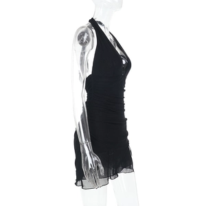 Detail of black halter neck mini dress featuring side ruching and sheer mesh fabric