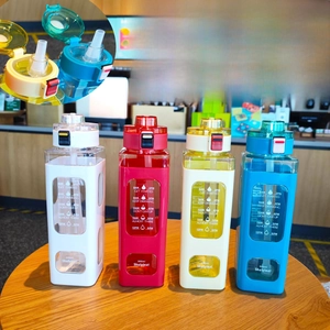 Detailed view of square 900ml water bottles with time markers and convenient carry strap