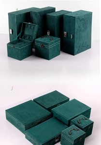 Detail of dark green velvet jewelry boxes with fine white stitching and retro metal locks