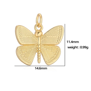 Macro view of gold butterfly pendant showing dimensions 14.6mm by 11.4mm and 0.99g weight