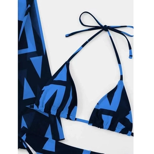 Detail of blue geometric print bikini with matching mesh cover-up and halter design