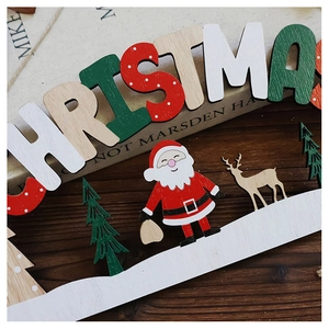 Close-up of wooden Christmas sign featuring Santa, reindeer and pine tree on snow base