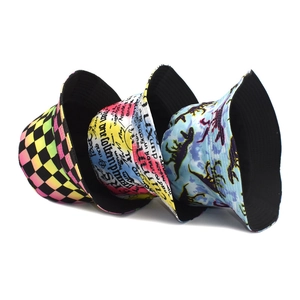 Three-pack reversible bucket hats with checkerboard, graffiti, and dinosaur print patterns