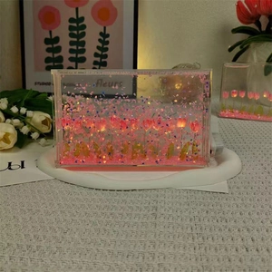 Macro view of tulip night light with glowing pink petals and shimmering glitter inside