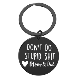 Detail of black round metal keychain with engraved text Don't Do Stupid Shit Mom and Dad
