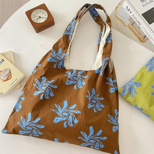 Detail view of large canvas tote bag with blue floral print and spacious inner lining
