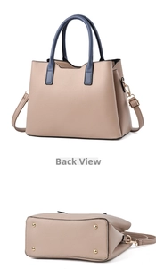 Detail view of the contrast color handbag with lychee pattern leather and gold metal studs
