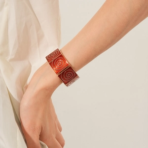 Detailed view of vintage enamel geometric square link bracelet in shades of red and gold