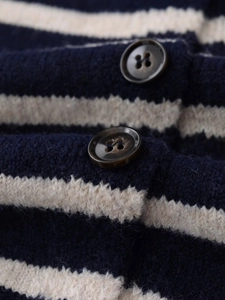 Detail of wool knit stripe cardigan featuring dark brown buttons and premium texture