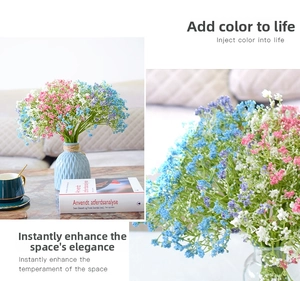 Detailed close-up of mixed artificial gypsophila flowers in a ceramic vase with home decor