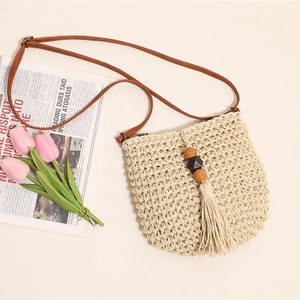 Minimalist beige woven straw crossbody bag with wood bead tassels and brown strap