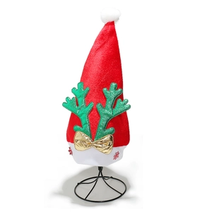 Detail of red Christmas hat with green sequin antlers and gold bow on white background