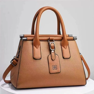 Elegant brown lychee grain leather handbag with dual handles and detachable strap