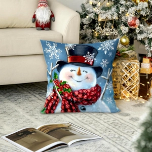 Detailed view of a snowman print Christmas pillowcase on a cozy white sofa with holiday decor