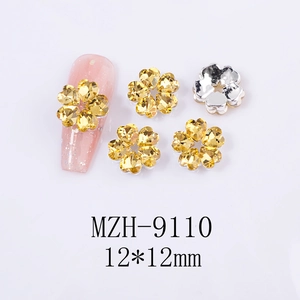Macro detail of yellow heart rhinestone nail charms showing 12mm size and floral design